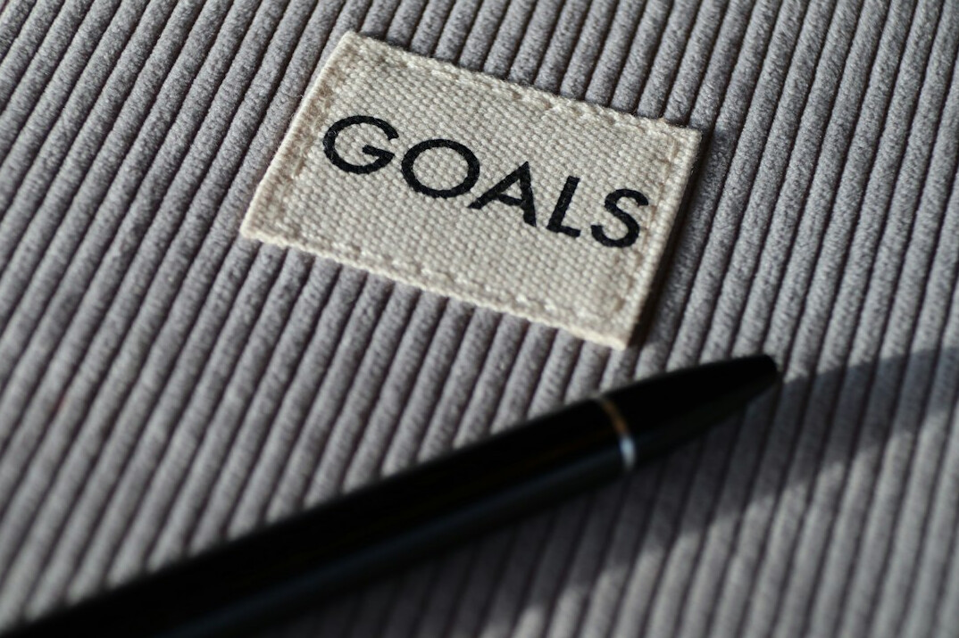 person tracking goals on notebook