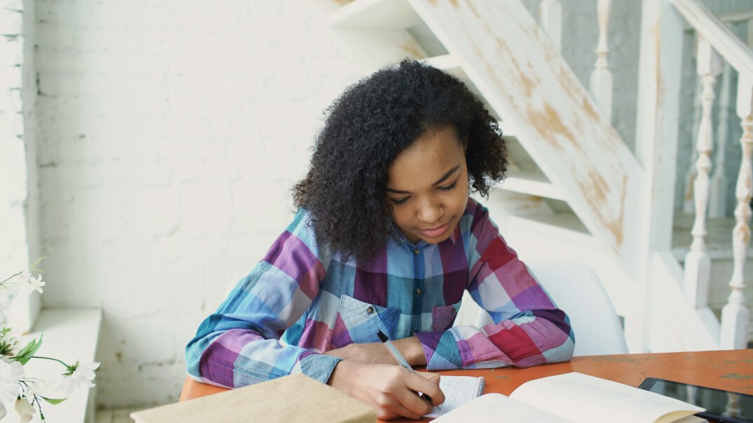 woman reading book at desk